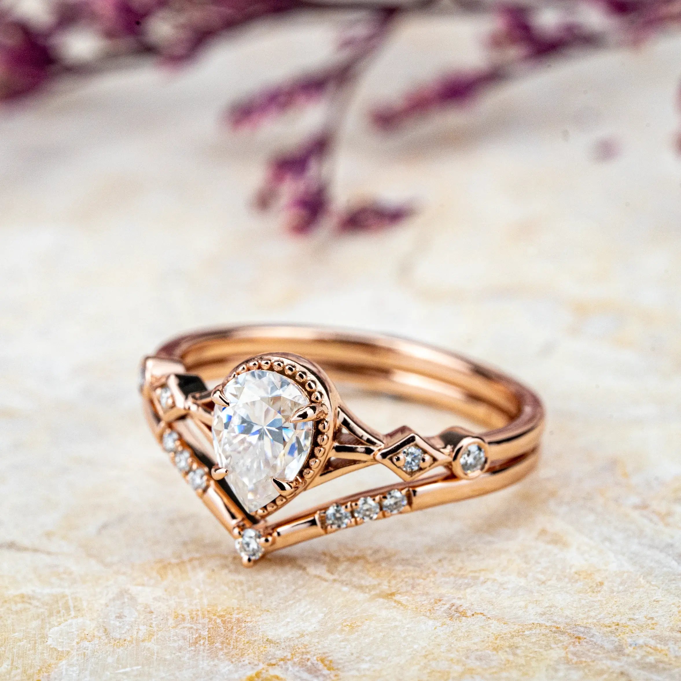 Ethereal Ring: a minimalist, custom handmade Moissanite proposal ring set. Features a pear-cut Moissanite on a rose gold band, blending modern elegance with classic romance. Perfect for an unforgettable engagement.