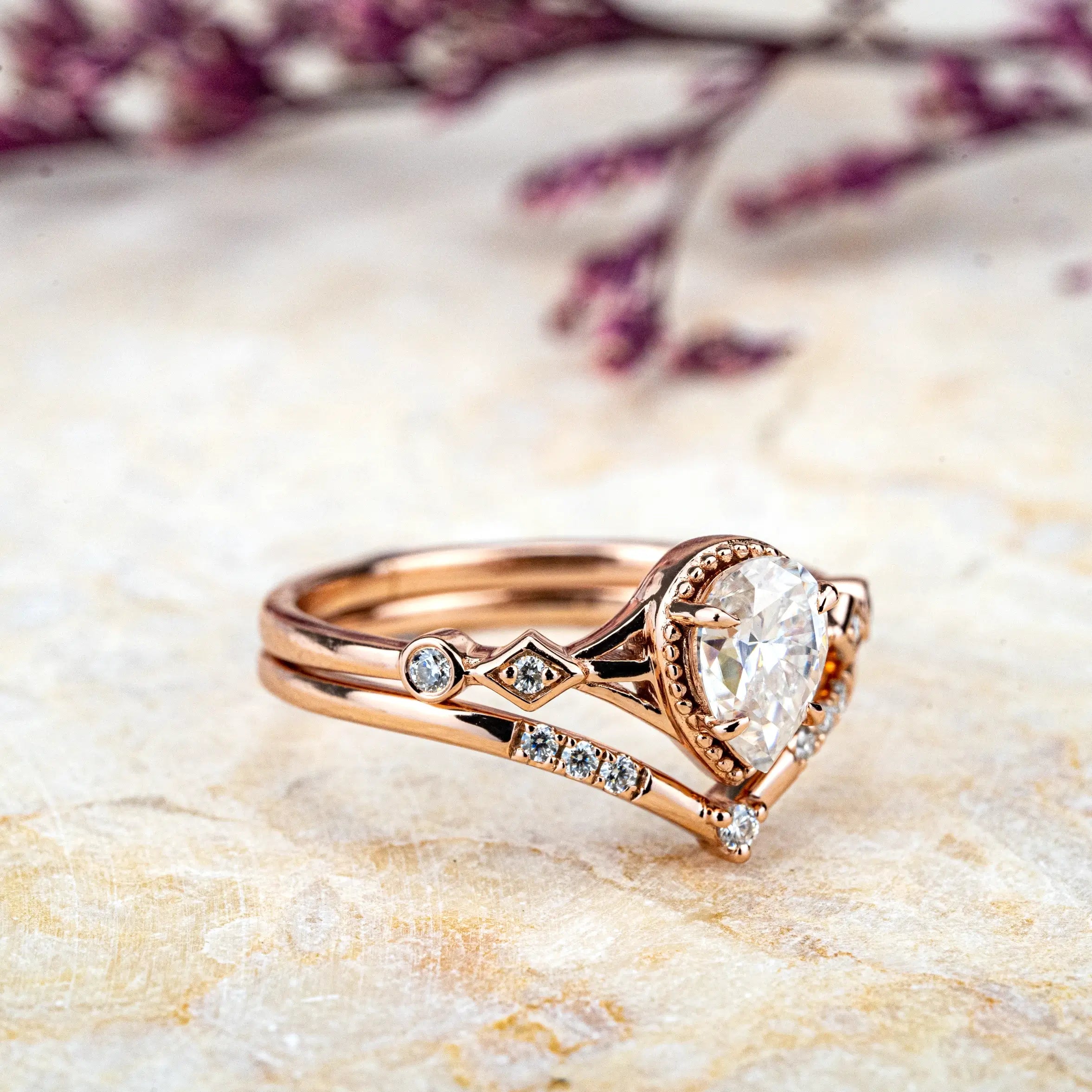 Ethereal Ring: a minimalist, custom handmade Moissanite proposal ring set. Features a pear-cut Moissanite on a rose gold band, blending modern elegance with classic romance. Perfect for an unforgettable engagement.