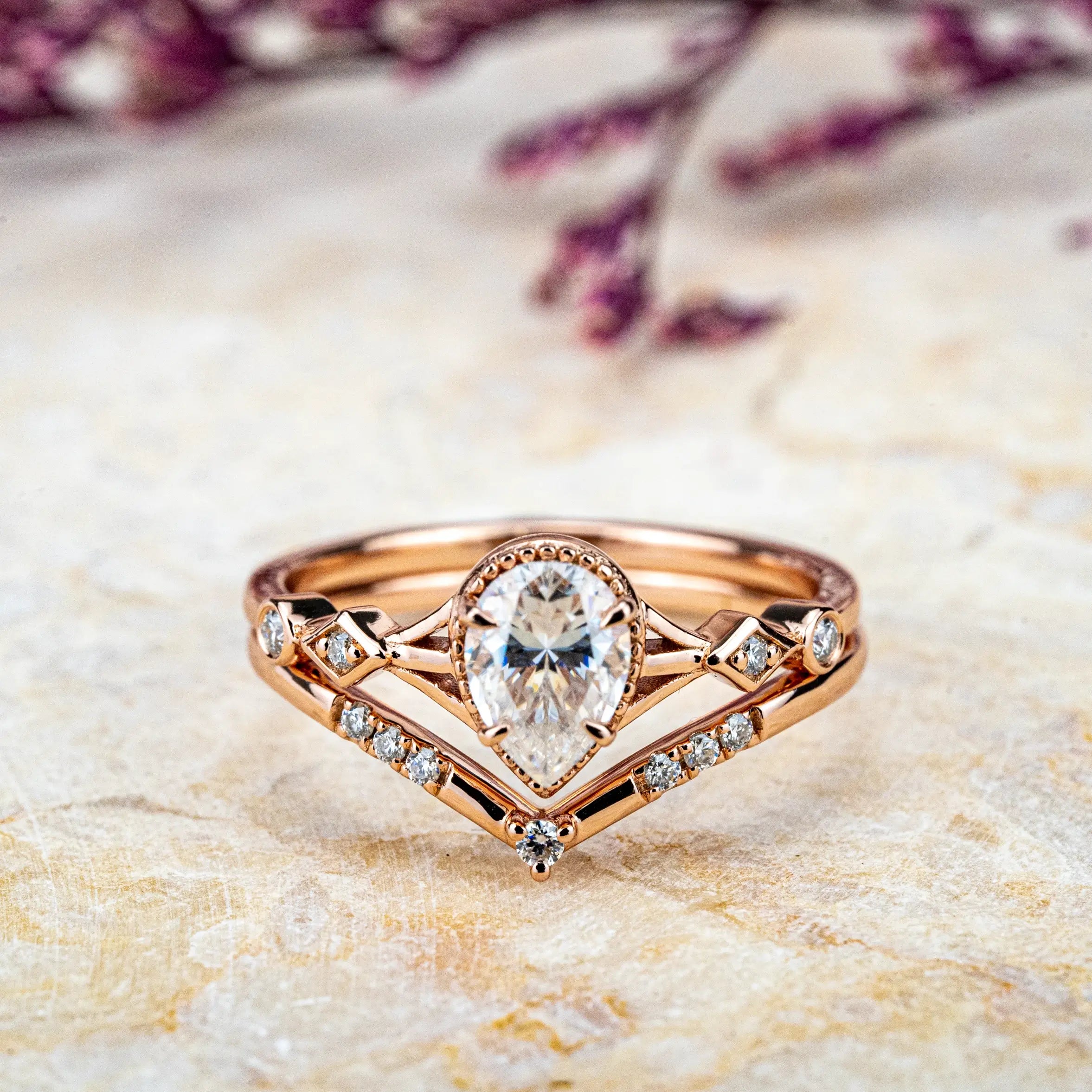 Ethereal Ring: a minimalist, custom handmade Moissanite proposal ring set. Features a pear-cut Moissanite on a rose gold band, blending modern elegance with classic romance. Perfect for an unforgettable engagement.